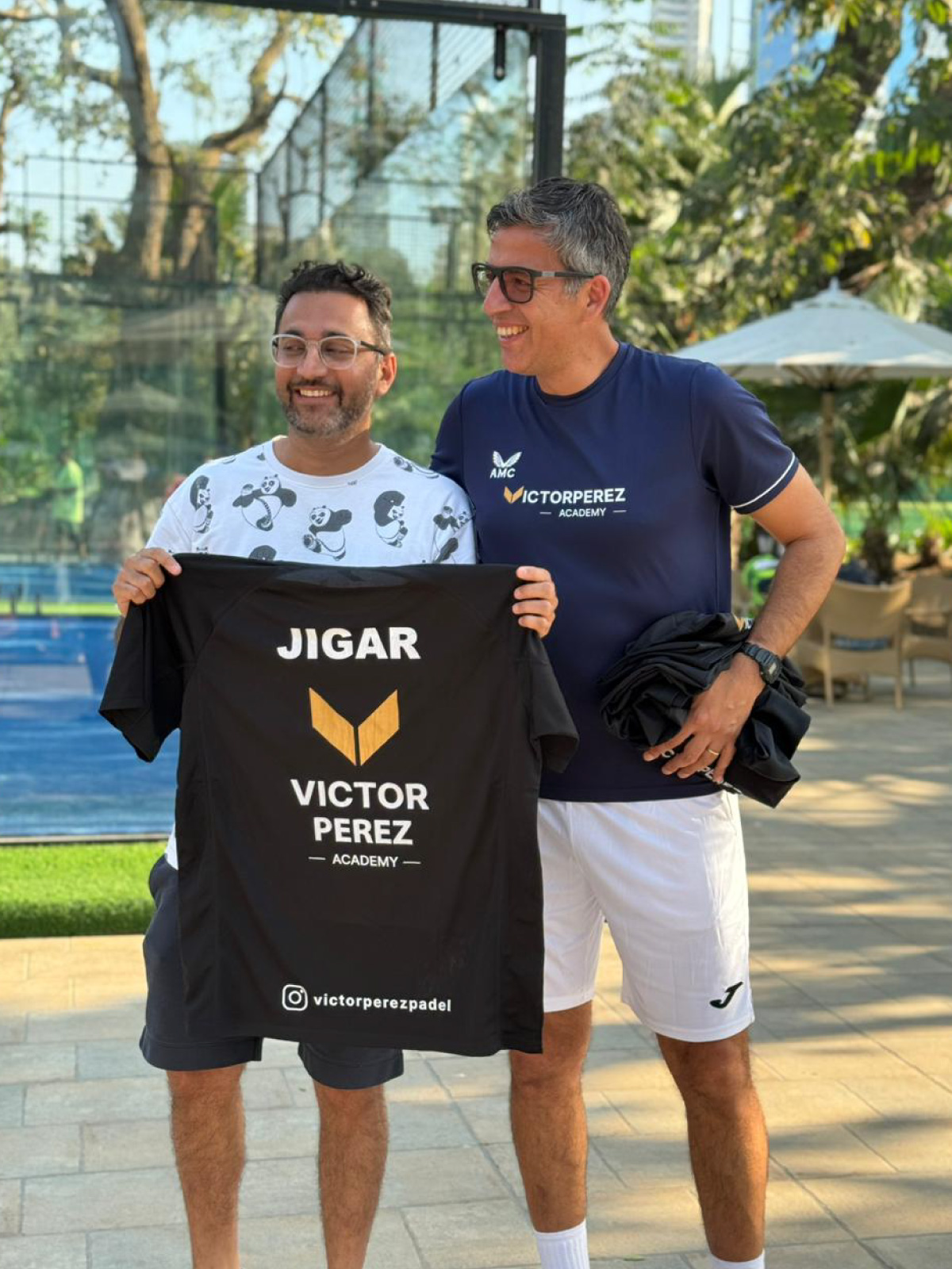Victor Perez with Jigar Doshi of Padel Park India, holding a Victor Perez Padel Academy shirt with his name on it