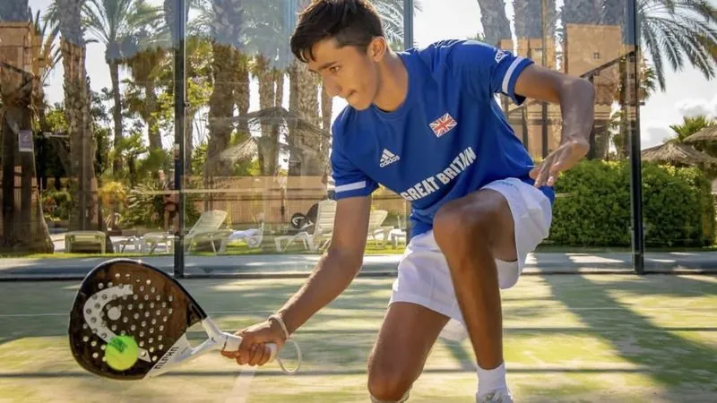 Nikhil Mohindra in the Great Britain team shirt playing padel, trained by padel coach Victor Perez